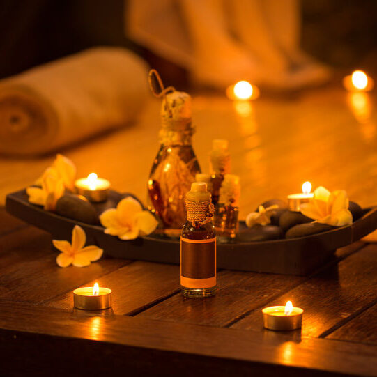 A candle lit table with candles and flowers.
